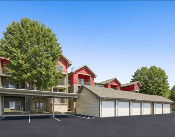 Red barn style apartment buildings with attached garages